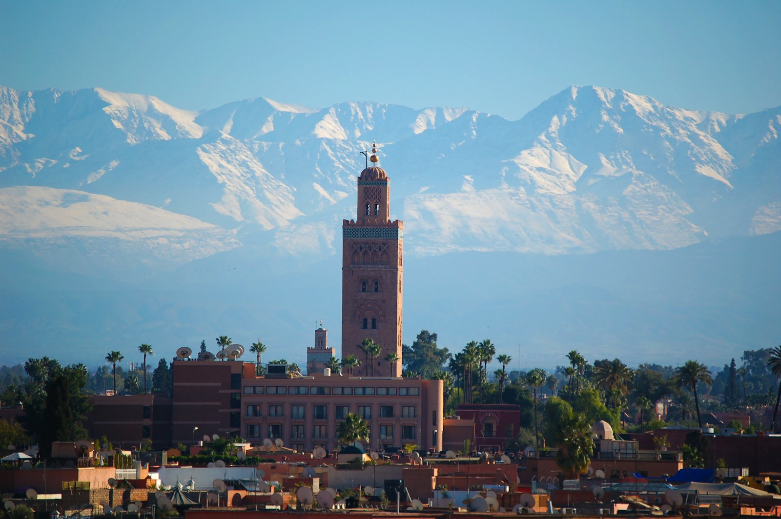 Koutoubia minaret with the snowy Atlas behind Marrakech